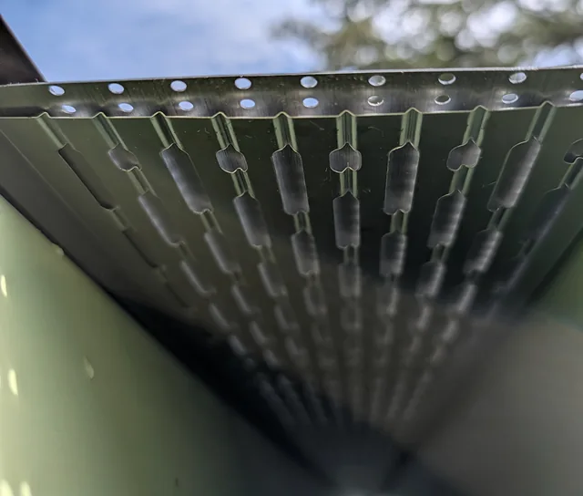 Underside of a gutter guard viewed through the open gutter end.