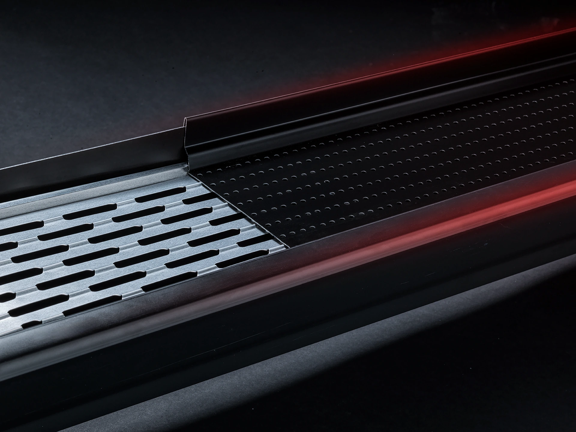 Close-up of the upper round perforations and lower slotted aluminum membrane